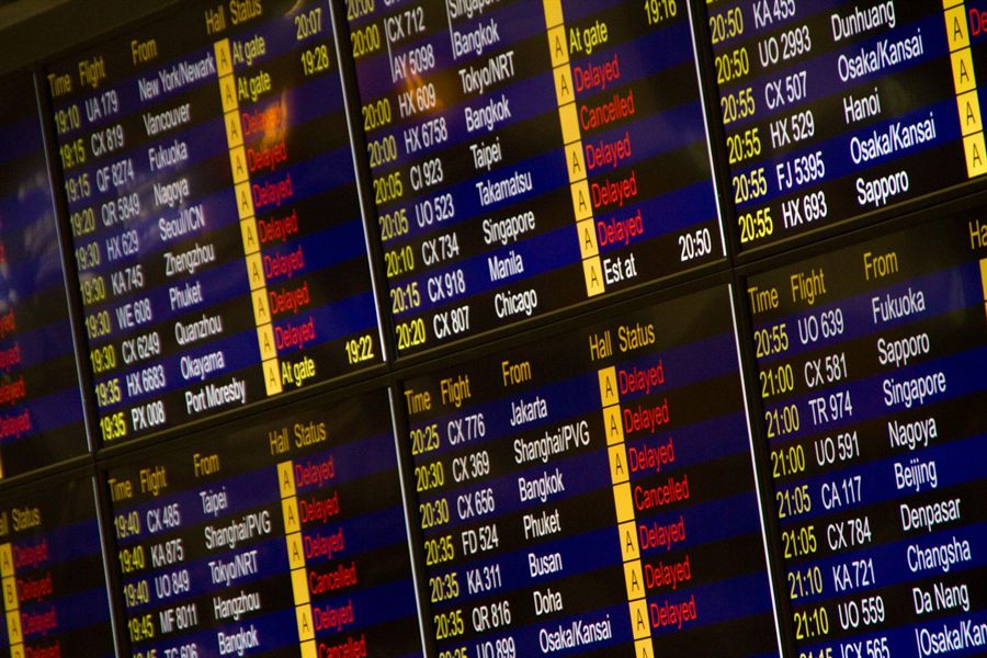 Close-up of airport flight information screens listing departures